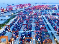 The container terminal of Taicang Port Phase 4 is being illuminated in Suzhou, Jiangsu province, China, on the evening of July 9, 2024. (