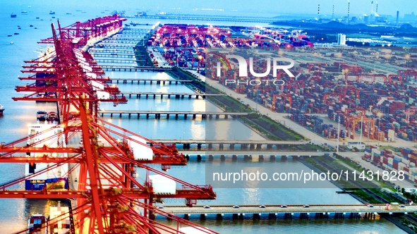 The container terminal of Taicang Port Phase 4 is being illuminated in Suzhou, Jiangsu province, China, on the evening of July 9, 2024. 