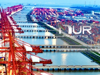 The container terminal of Taicang Port Phase 4 is being illuminated in Suzhou, Jiangsu province, China, on the evening of July 9, 2024. (