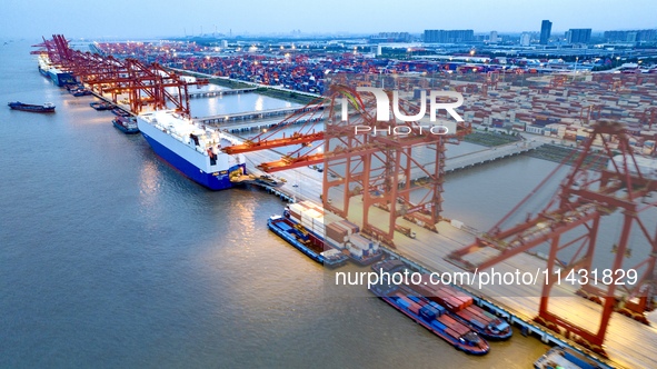 The container terminal of Taicang Port Phase 4 is being illuminated in Suzhou, Jiangsu province, China, on the evening of July 9, 2024. 