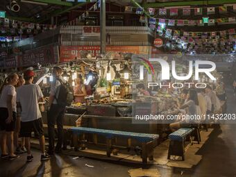 A general view is showing the South Korean traditional food court at Gwangjang Market in Seoul, South Korea. Gwangjang Market is being a tra...