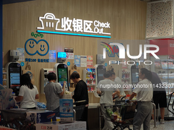 Customers are shopping at a Freshippo store in the Huangpu district of Shanghai, China, on July 25, 2024. (