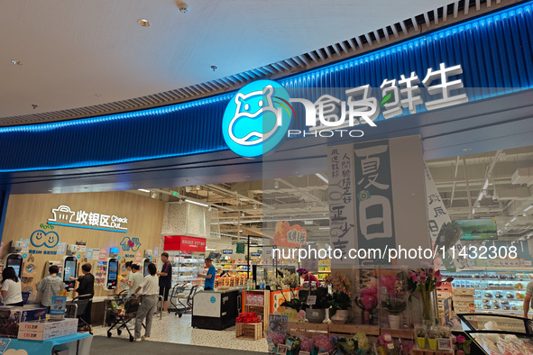 Customers are shopping at a Freshippo store in the Huangpu district of Shanghai, China, on July 25, 2024. 