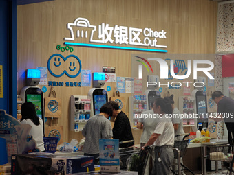 Customers are shopping at a Freshippo store in the Huangpu district of Shanghai, China, on July 25, 2024. (