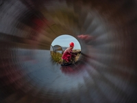 Workers are installing fiberglass tubes in a high-standard farmland in Karamay, China, on July 24, 2024. (