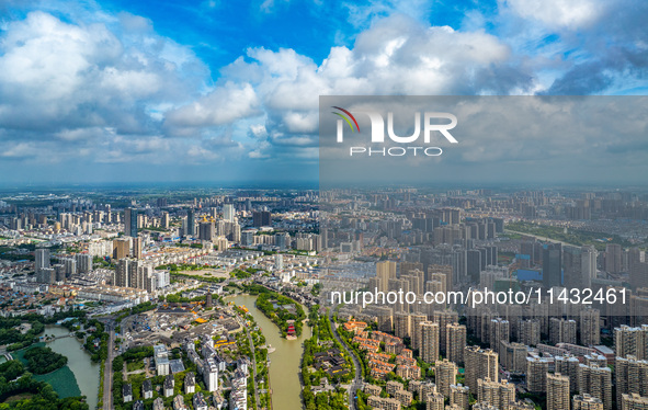 An aerial photo is showing urban buildings under the blue sky and white clouds in Huai'an City, East China's Jiangsu province, on July 25, 2...