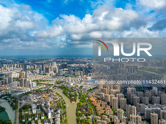 An aerial photo is showing urban buildings under the blue sky and white clouds in Huai'an City, East China's Jiangsu province, on July 25, 2...