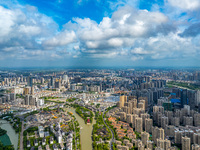 An aerial photo is showing urban buildings under the blue sky and white clouds in Huai'an City, East China's Jiangsu province, on July 25, 2...