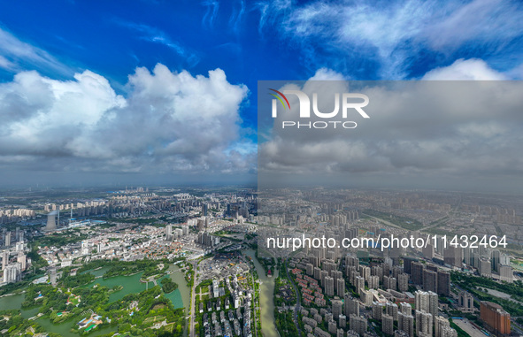 An aerial photo is showing urban buildings under the blue sky and white clouds in Huai'an City, East China's Jiangsu province, on July 25, 2...