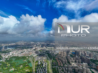 An aerial photo is showing urban buildings under the blue sky and white clouds in Huai'an City, East China's Jiangsu province, on July 25, 2...