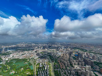 An aerial photo is showing urban buildings under the blue sky and white clouds in Huai'an City, East China's Jiangsu province, on July 25, 2...