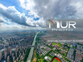 An aerial photo is showing urban buildings under the blue sky and white clouds in Huai'an City, East China's Jiangsu province, on July 25, 2...