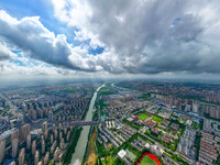 An aerial photo is showing urban buildings under the blue sky and white clouds in Huai'an City, East China's Jiangsu province, on July 25, 2...