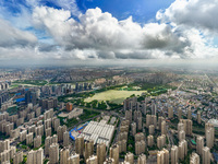 An aerial photo is showing urban buildings under the blue sky and white clouds in Huai'an City, East China's Jiangsu province, on July 25, 2...