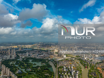 An aerial photo is showing urban buildings under the blue sky and white clouds in Huai'an City, East China's Jiangsu province, on July 25, 2...