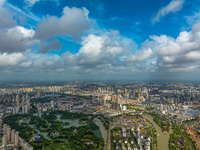 An aerial photo is showing urban buildings under the blue sky and white clouds in Huai'an City, East China's Jiangsu province, on July 25, 2...