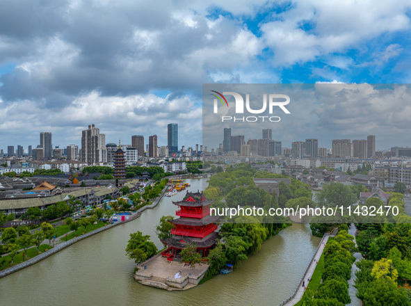 An aerial photo is showing urban buildings under the blue sky and white clouds in Huai'an City, East China's Jiangsu province, on July 25, 2...