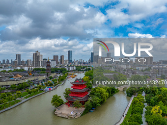 An aerial photo is showing urban buildings under the blue sky and white clouds in Huai'an City, East China's Jiangsu province, on July 25, 2...