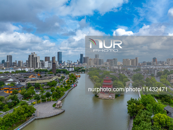 An aerial photo is showing urban buildings under the blue sky and white clouds in Huai'an City, East China's Jiangsu province, on July 25, 2...