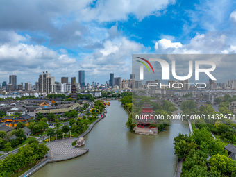 An aerial photo is showing urban buildings under the blue sky and white clouds in Huai'an City, East China's Jiangsu province, on July 25, 2...