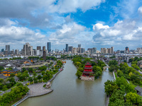 An aerial photo is showing urban buildings under the blue sky and white clouds in Huai'an City, East China's Jiangsu province, on July 25, 2...