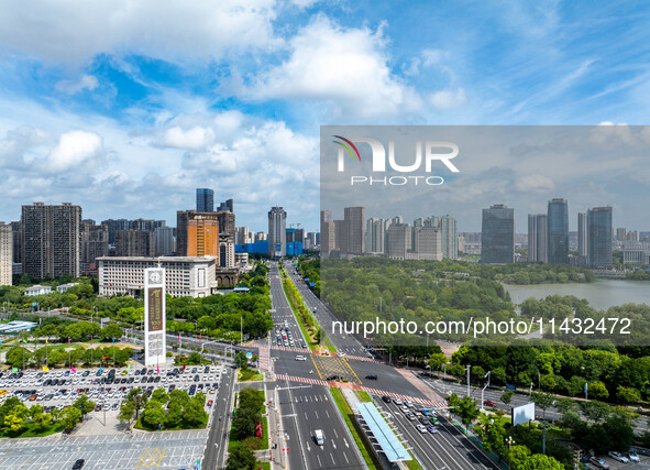 An aerial photo is showing urban buildings under the blue sky and white clouds in Huai'an City, East China's Jiangsu province, on July 25, 2...