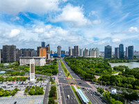 An aerial photo is showing urban buildings under the blue sky and white clouds in Huai'an City, East China's Jiangsu province, on July 25, 2...