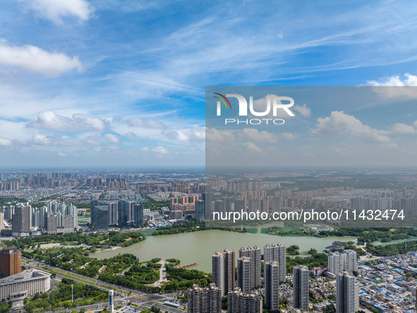 An aerial photo is showing urban buildings under the blue sky and white clouds in Huai'an City, East China's Jiangsu province, on July 25, 2...