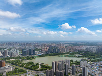 An aerial photo is showing urban buildings under the blue sky and white clouds in Huai'an City, East China's Jiangsu province, on July 25, 2...