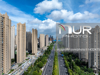 An aerial photo is showing urban buildings under the blue sky and white clouds in Huai'an City, East China's Jiangsu province, on July 25, 2...