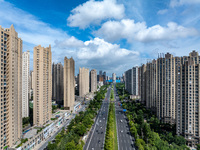 An aerial photo is showing urban buildings under the blue sky and white clouds in Huai'an City, East China's Jiangsu province, on July 25, 2...