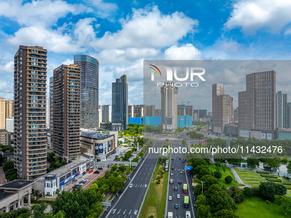 An aerial photo is showing urban buildings under the blue sky and white clouds in Huai'an City, East China's Jiangsu province, on July 25, 2...