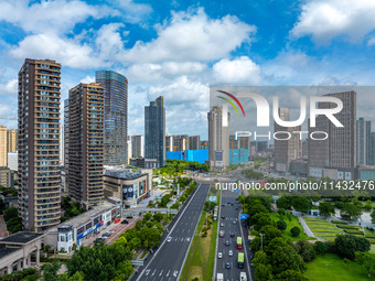 An aerial photo is showing urban buildings under the blue sky and white clouds in Huai'an City, East China's Jiangsu province, on July 25, 2...