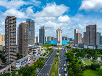 An aerial photo is showing urban buildings under the blue sky and white clouds in Huai'an City, East China's Jiangsu province, on July 25, 2...