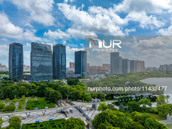 An aerial photo is showing urban buildings under the blue sky and white clouds in Huai'an City, East China's Jiangsu province, on July 25, 2...