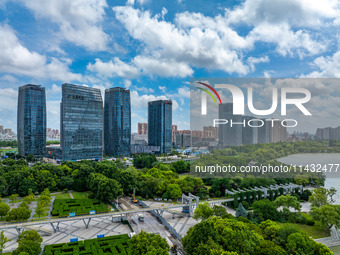 An aerial photo is showing urban buildings under the blue sky and white clouds in Huai'an City, East China's Jiangsu province, on July 25, 2...