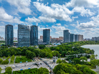 An aerial photo is showing urban buildings under the blue sky and white clouds in Huai'an City, East China's Jiangsu province, on July 25, 2...