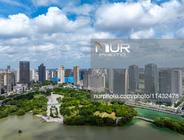 An aerial photo is showing urban buildings under the blue sky and white clouds in Huai'an City, East China's Jiangsu province, on July 25, 2...