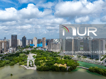 An aerial photo is showing urban buildings under the blue sky and white clouds in Huai'an City, East China's Jiangsu province, on July 25, 2...