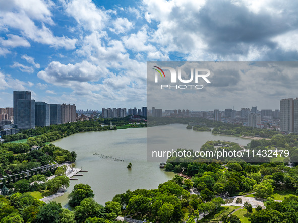 An aerial photo is showing urban buildings under the blue sky and white clouds in Huai'an City, East China's Jiangsu province, on July 25, 2...