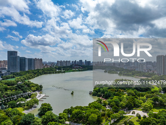 An aerial photo is showing urban buildings under the blue sky and white clouds in Huai'an City, East China's Jiangsu province, on July 25, 2...