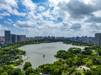 An aerial photo is showing urban buildings under the blue sky and white clouds in Huai'an City, East China's Jiangsu province, on July 25, 2...