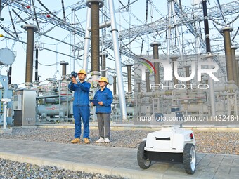 An intelligent inspection robot and operation and maintenance personnel are braving high temperatures to inspect the power supply equipment...