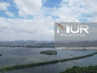 Winds and clouds are rising above the West Lake affected by Typhoon Kaemi in Hangzhou, China, on July 25, 2024. (