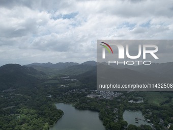 Winds and clouds are rising above the West Lake affected by Typhoon Kaemi in Hangzhou, China, on July 25, 2024. (