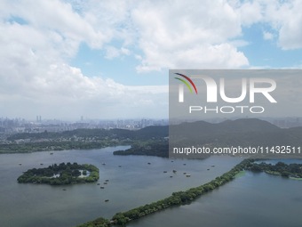 Winds and clouds are rising above the West Lake affected by Typhoon Kaemi in Hangzhou, China, on July 25, 2024. (