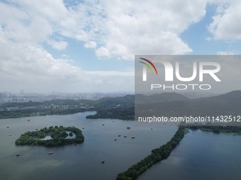 Winds and clouds are rising above the West Lake affected by Typhoon Kaemi in Hangzhou, China, on July 25, 2024. (