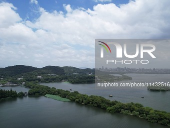 Winds and clouds are rising above the West Lake affected by Typhoon Kaemi in Hangzhou, China, on July 25, 2024. (