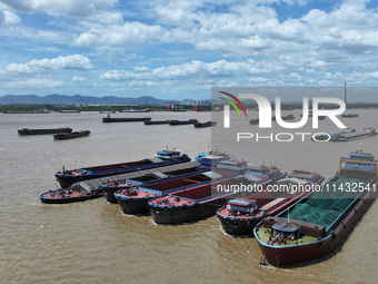 Cargo ships are anchoring in the waters of the Nanjing section of the Yangtze River in Nanjing, Jiangsu province, China, on July 25, 2024. O...