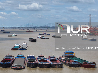 Cargo ships are anchoring in the waters of the Nanjing section of the Yangtze River in Nanjing, Jiangsu province, China, on July 25, 2024. O...